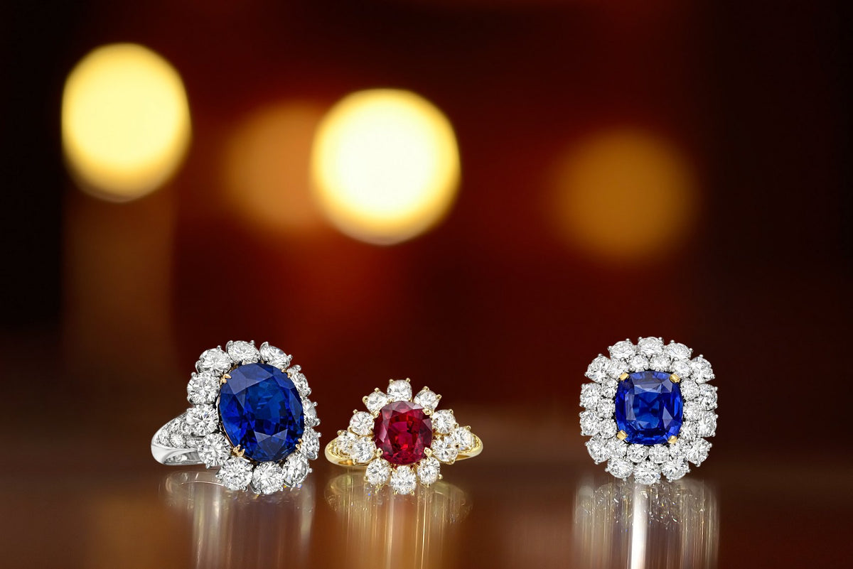 Two sapphire and diamond cluster rings and a ruby and diamond cluster ring made by Greenleaf & Crosby