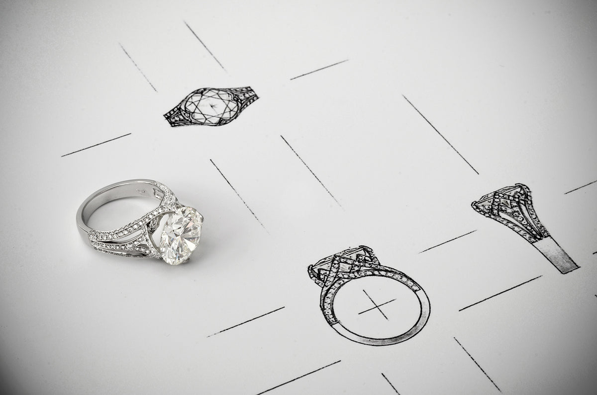 A diamond ring beside pencil design sketches of the same ring